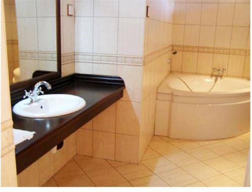 a bathroom with a sink and a toilet at Ryan's Bay Hotel in Mwanza