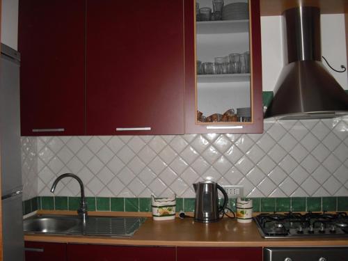 a kitchen counter with a sink and a stove at Villa Emiri in Cefalù