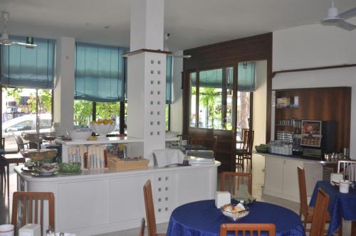 a kitchen with a table with a blue table cloth at Hotel Villa Candia in Lignano Sabbiadoro