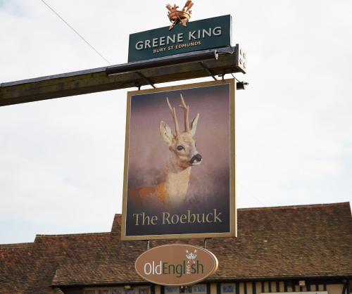 a sign for a reindeer on the side of a building at Roebuck by Greene King Inns in Forest Row