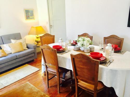 a dining room with a table and a couch at BS Villas Porto in Porto