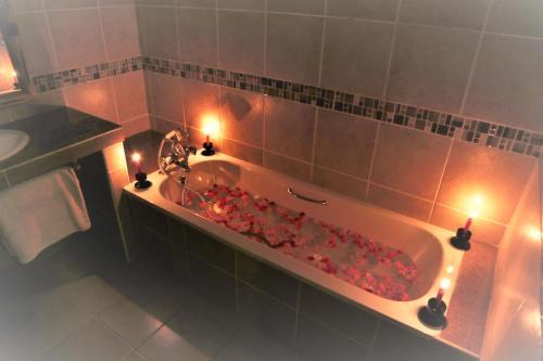 a bathroom with a bath tub with candles in it at Voi Wildlife Lodge in Voi