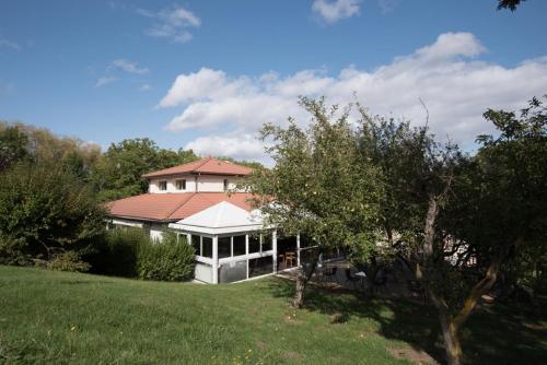 une grande maison blanche avec un toit rouge dans l'établissement Hôtel Restaurant L'Artière, à Ceyrat