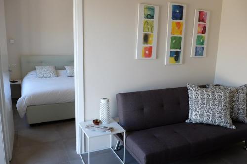 a living room with a couch and a bed and a mirror at Acqua Dolce in Rio Marina