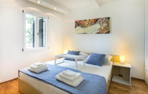 a bedroom with a bed with towels on it at Apartment Stefan in Sveti Stefan