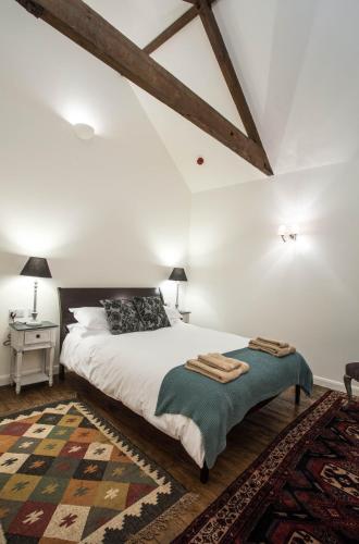 a bedroom with a large white bed and a rug at Tailor Room 2 in Lincoln