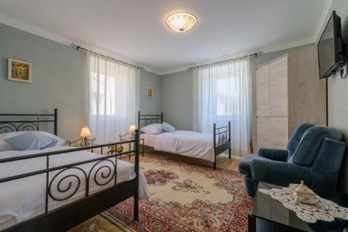 a bedroom with two beds and a living room at Villa Andante in Trogir