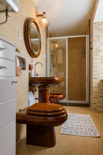 a bathroom with a wooden toilet and a shower at Villa Andante in Trogir
