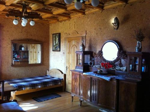 a bedroom with a bed and a table and a window at Sykytura in Sheshory