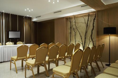 a row of chairs in a room with a table at Porto Palace Hotel Thessaloniki in Thessaloniki