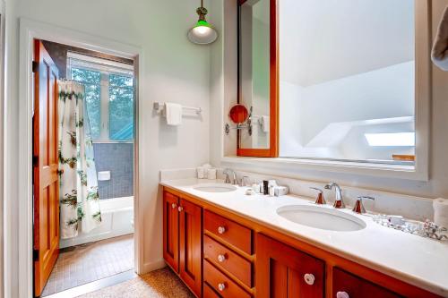 a bathroom with two sinks and a large mirror at The Forest Neighborhood by Keystone Resort in Keystone