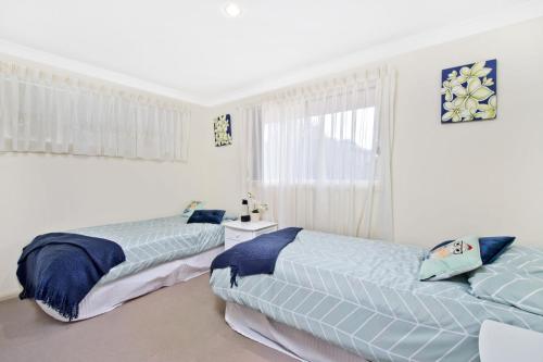 a bedroom with two beds and a window at 354 Owen Street Port Macquarie in Port Macquarie