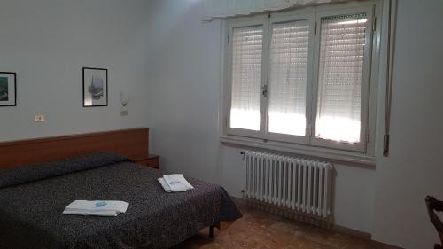 a bedroom with a bed and a window at Albergo Sonia in Florence