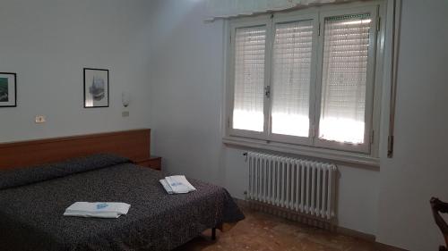 Postel nebo postele na pokoji v ubytování Albergo Sonia