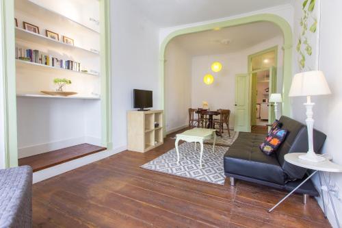 a living room with a couch and a table at Alfama Tailor Made Green House With a View #2 in Lisbon