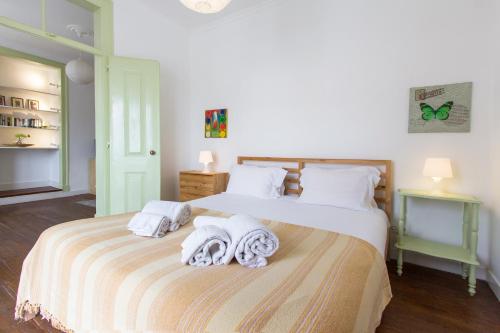 a bedroom with two beds with towels on them at Alfama Tailor Made Green House With a View #2 in Lisbon
