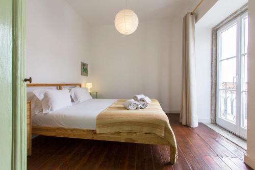 a bedroom with a bed with two stuffed animals on it at Alfama Tailor Made Green House With a View #2 in Lisbon