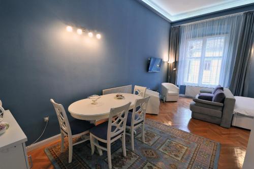 a small living room with a table and a bed at Apartment 9 - City centre in Sibiu