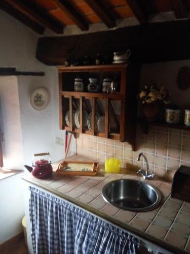 a kitchen with a sink and a counter top at Casa Vacanze del Borgo in Sassetta