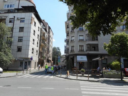 a city street with buildings and a crosswalk at Sensitive Apartment in Belgrade