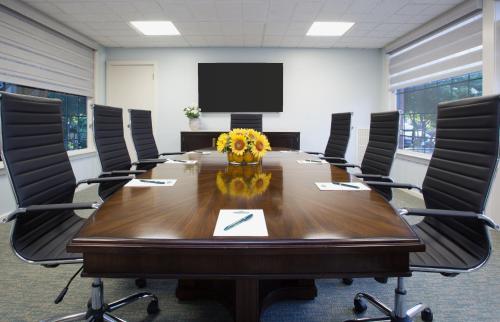 a conference room with a large wooden table and chairs at The Bellmoor Inn and Spa in Rehoboth Beach