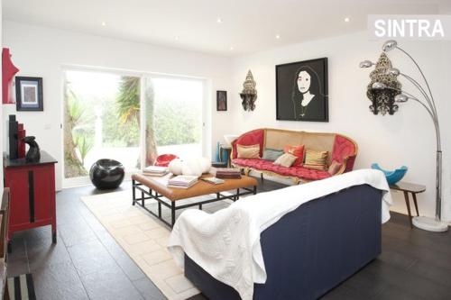 a living room with a couch and a table at Heaven in the Sintra Forest - with pool in Sintra
