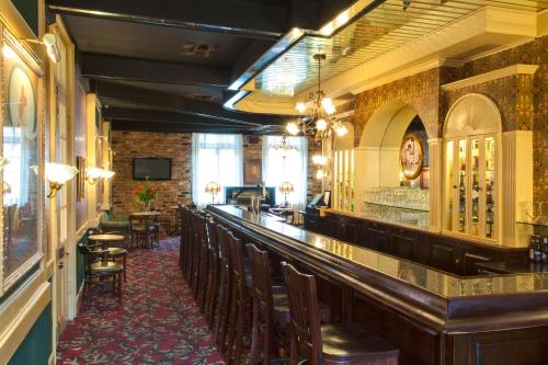 a bar with a row of chairs in a restaurant at Dauphine Orleans Hotel in New Orleans