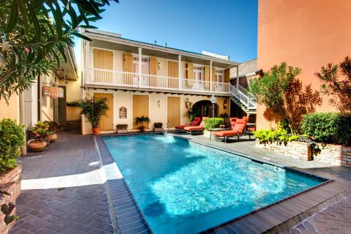 a swimming pool in front of a house at Dauphine Orleans Hotel in New Orleans