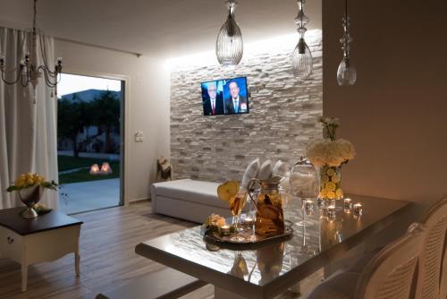a living room with a table with food on it at Stelios Gardens in Malia
