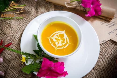 a cup of tea on a plate with flowers at Tuan Nam Homestay in Ninh Binh