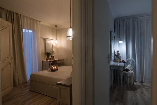 a bedroom with a bed and a table and a mirror at Stelios Gardens in Malia