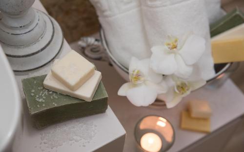 a table with soap and white flowers on it at Stelios Gardens in Malia