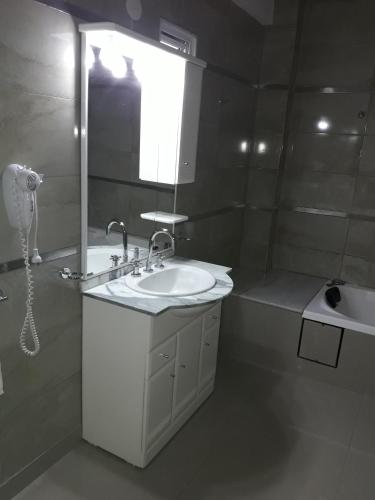 a bathroom with a sink and a mirror at Apart Ma & Cris II in Termas de Río Hondo