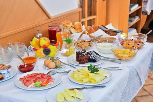 a table with many plates of food on it at Pension SONNECK in Valles