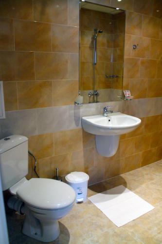 a bathroom with a toilet and a sink at Garden Guest House in Sandanski