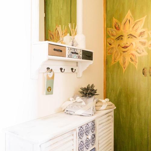 a bathroom with a mirror and a white cabinet at B&B La Zolla in Impruneta