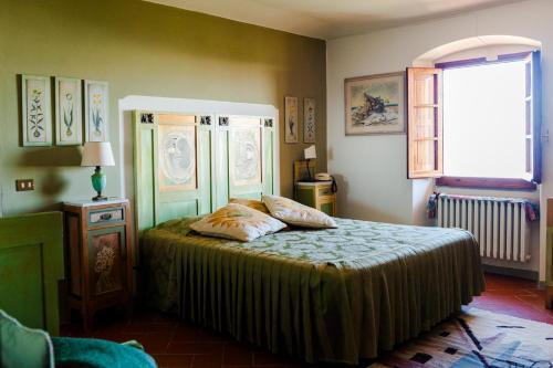 a bedroom with a bed with two pillows on it at B&B La Zolla in Impruneta