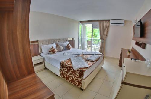 Postel nebo postele na pokoji v ubytování Jijo's Hotel