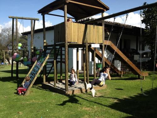 a group of children playing in a wooden playground at Hacienda Hosteria Chorlavi in Ibarra