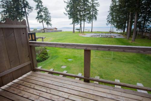 a wooden porch with a view of a park at Ocean Resort in Oyster Bay