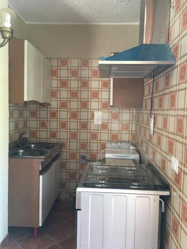 a small kitchen with a stove and a sink at Villa Angelica in Vibo Valentia Marina