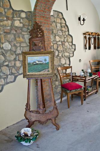 a picture frame on a stand in front of a stone wall at Tenuta Terensano in Monleale
