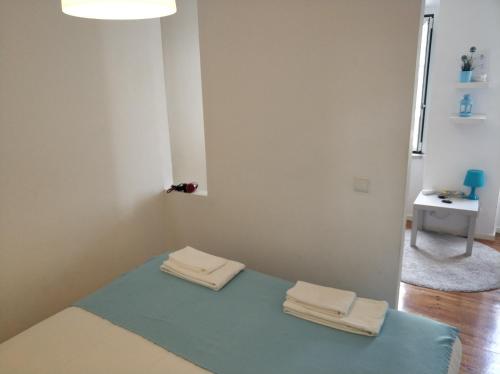 a room with two towels sitting on a blue rug at Alcantara Quiet & Calm in Lisbon in Lisbon