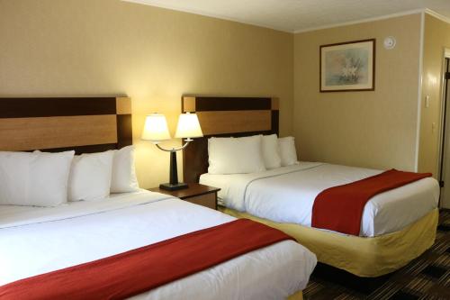 um quarto de hotel com duas camas e duas lâmpadas em Castlewood Inn em Maggie Valley