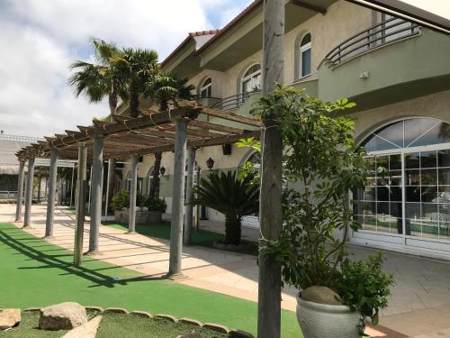 a pergola in front of a building at Hospedium Hotel Twist in Torredonjimeno