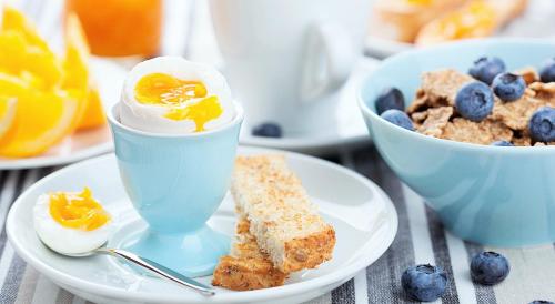 a plate with an egg and bread and a bowl of fruit at Resort Atlantic Villas & Spa in Punta Cana