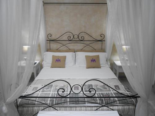 a bedroom with a bed with a wrought iron headboard at Mattandre in Monteroni di Lecce