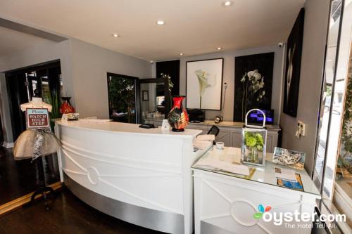 a living room with a white counter and a room with windows at L.A. Sky Boutique Hotel in Los Angeles
