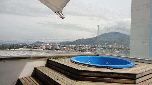 a blue bath tub sitting on top of a roof at Habitat Suites Hotel By GHO Hoteles in Pereira