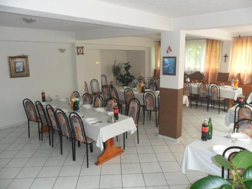 a dining room with tables and chairs in a restaurant at Sobe u kucanstvu MBM in Međugorje